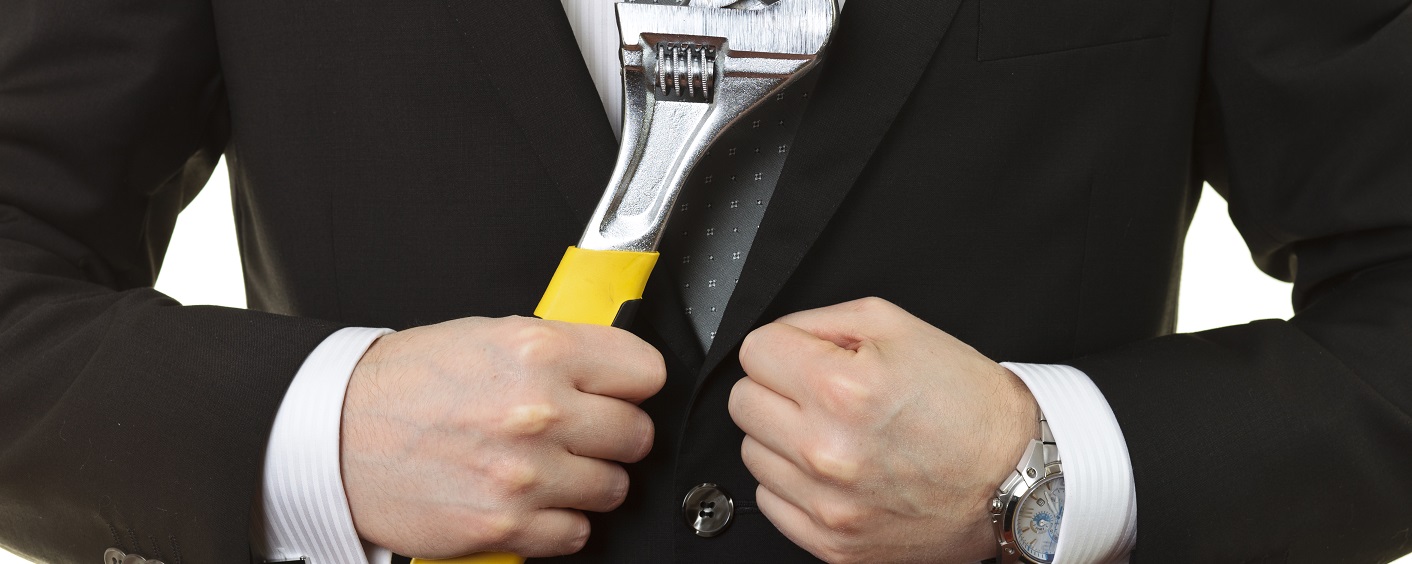Busienssman with a wrench Busienssman with a wrench. Concept for bad economics and crisis in financial world.